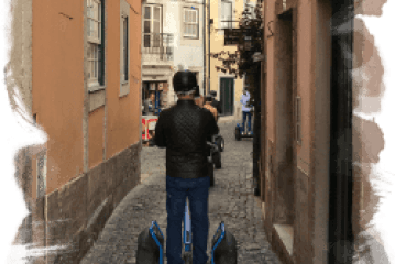a person walking down a street next to a building