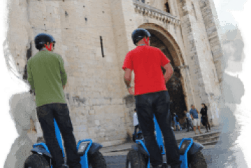 a group of people riding skis on a snowy road