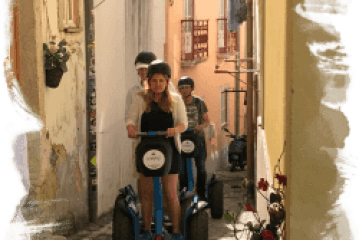 a person riding a bicycle in front of a building