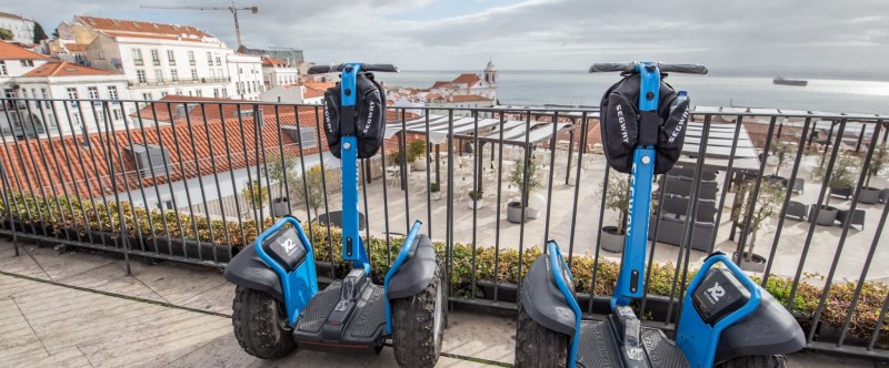 a group of parked motorcycles sitting on the side of a fence